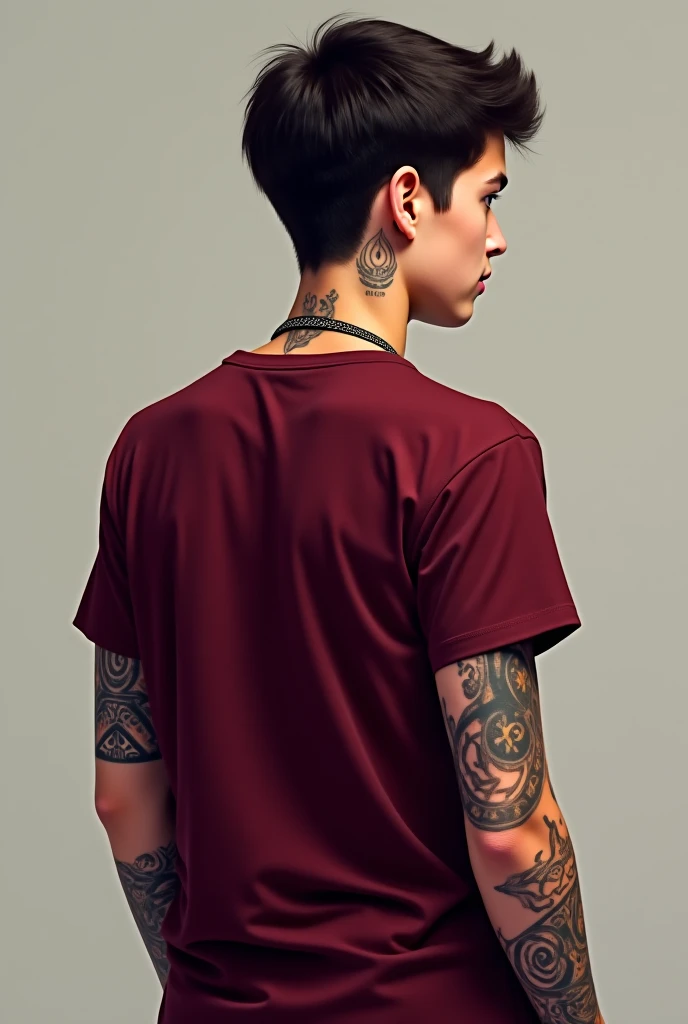  An image of a teenage boy with his back .  He wears a burgundy red short-sleeve t-shirt . There are tattoos on . his arms and his hair is dark brown and short

