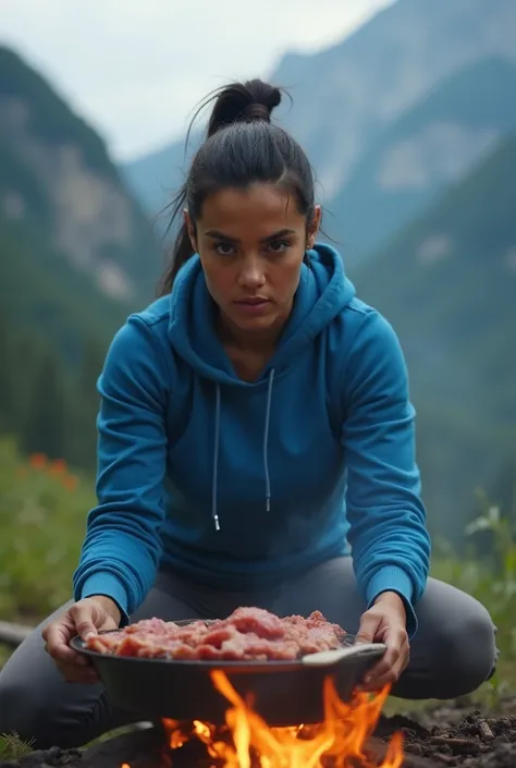 Realistic Latin woman with dark hair tied up with a ponytail,  brown eyes ,  tight blue sweatshirt . camping in the mountains , Cooking meat on a campfire
