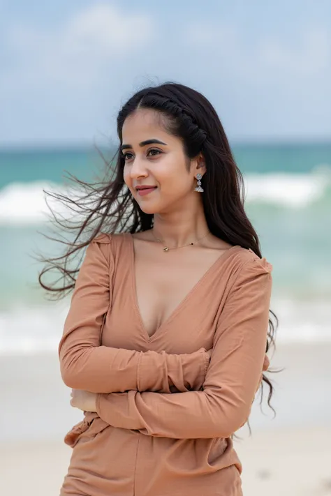 A busty woman with long black braided hair, wearing a tight deep-neck T-shirt and casual shorts, standing on a sandy beach with waves crashing behind her under a bright blue sky.