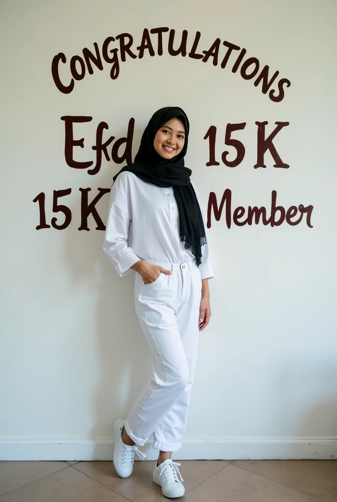 A beautiful young Indonesian native woman with white skin smiling sweetly wearing a black pasmina hijab white shirt white cargo pants white shoes is standing on a wall painting a name" CONGRATULATIONS EFKD 15 K MEMBER" written with calligraphy beautiful fo...