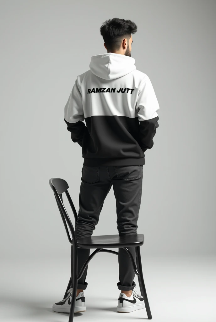 Create a 8k illusion for a profile picture where a 25 Year old cute boy in a white and blackhoodie  stand casually on a back chair. Wearing sneakers, with my name Ramzan Jutt back side big name