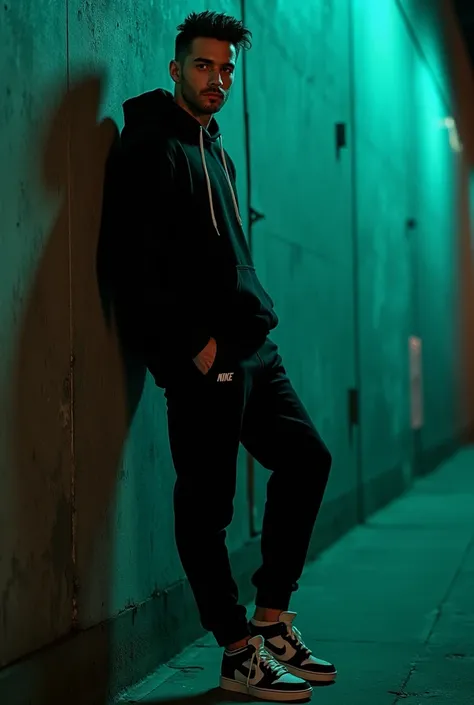 A handsome athletic guy, male model sicilian flare, no beard and moustache, leaning casually against standing a dark urban textured wall with dramatic shadow play, wearing a basic black hoodie, nike basic pants, and Nike Dunk SB shoes. His hands are in his...