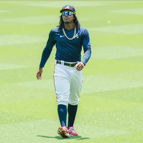 Ronald Acuña Jr .,  wearing the Atlanta Braves uniform ,  celebrating on the field with energy and emotion . In the picture,  holds a base in their hands while fans applaud .  His face reflects pride and determination after making MLB history with 40 home ...