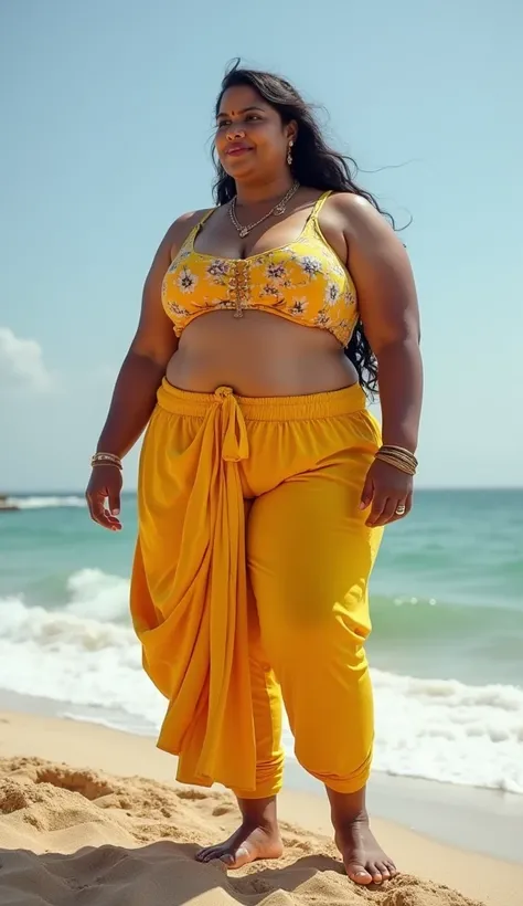 A full-body photograph of a voluptuous South Indian mature aunty with an extra-large (15XL) physique, standing on the sandy beach. She is wearing a floral yellow crop rop and ankle length leggings that accentuates her curvy figure. Her enormous, round, and...