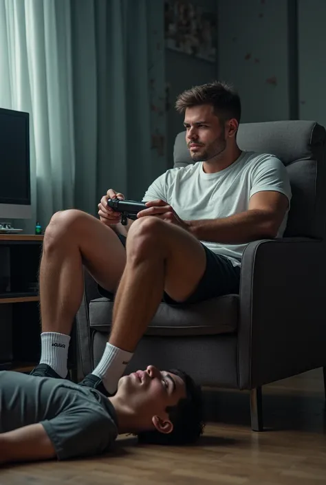 Un jeune homme sportif en New Balance boueuses, assis sur une chaise, joue de la console et piétine un autre jeune homme allongé par terre sous ses pieds. Les pieds sur son visage.