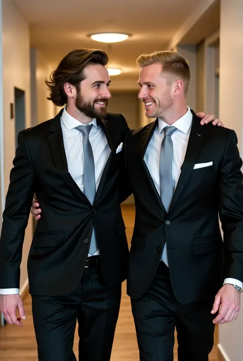 Handsome mature Norwegian man with shoulder-length hair with a thin beard dressed in a black groom's suit wearing a white shirt and gray tie holding a handsome young white man with short blond hair with a budding beard dressed in a black groom's suit with ...