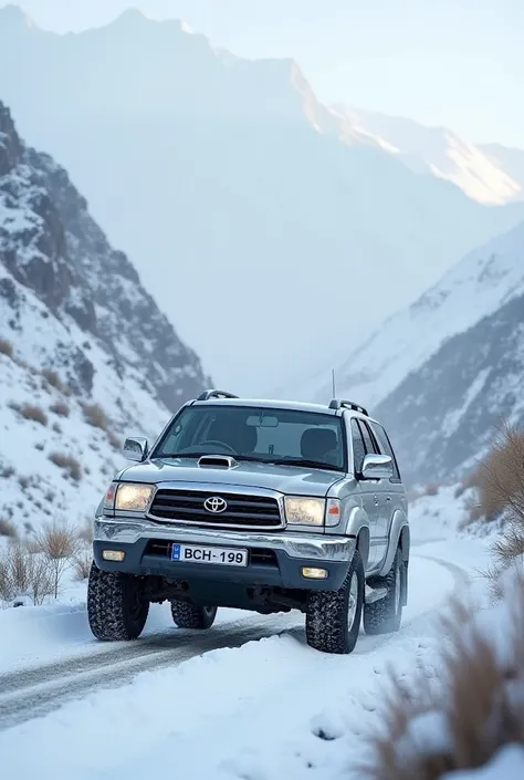 Toyota Hilux surf 2003 in silver wiyh Islamabad number plate written BCH-169 on it, in a snowy mountain road