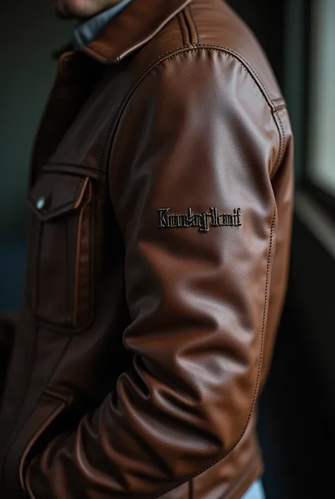 A close-up of Liam’s leather jacket, slightly worn but carefully stitched, with a small embroidered name on the sleeve. The background is blurred, emphasizing the sentimental value of the jacket.
