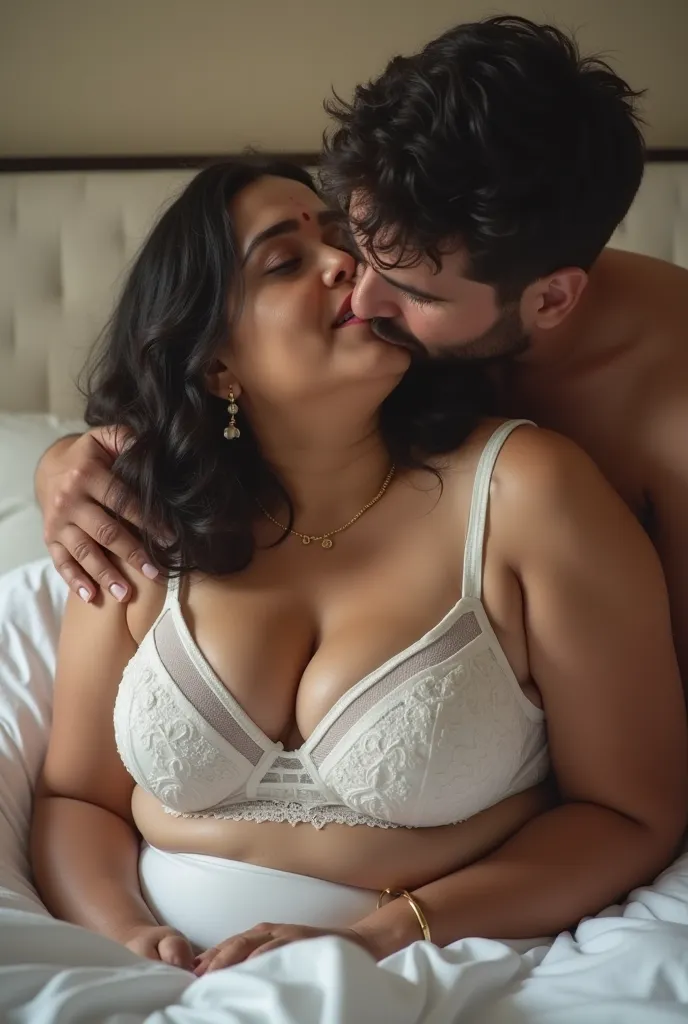 Indian 60 year old bbw chubby plus sized wife ,(wearing white colour transparent deep neck  cleavage bra, very huge swooping breasts) and 27 year old shirtless man driver kissing on bed. very bright light, front view 