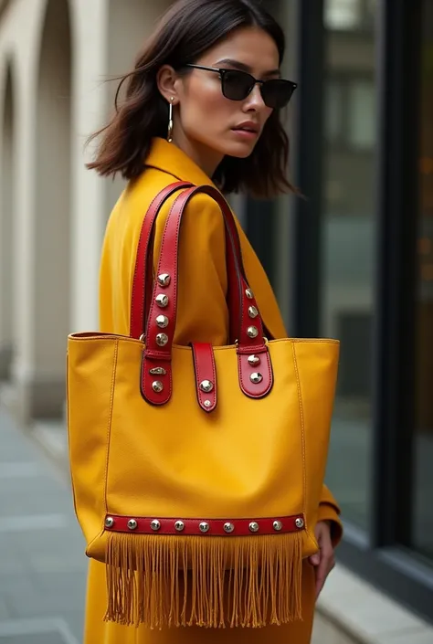 woman wearing a yellow cow leather tote bag combined with red with estoperoles silver buckle and strips of thread on the bottom 