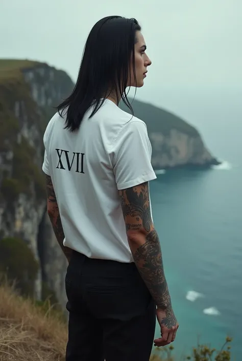 a tall man 1 ,90% tall straight black hair above the shoulders, Wearing black pants dress a white shirt with an arm full of tattoos, with the number XVII written around the neck , At the edge of a cliff 