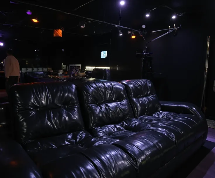 Full panoramic view of scene from below, RAW amateur selfie photo, high resolution, huge inflated sofa made of shiny black rubber, the texture of the sofa is very shiny and wet detailed, inside a room illuminated from below with a black Neon powerful, conc...