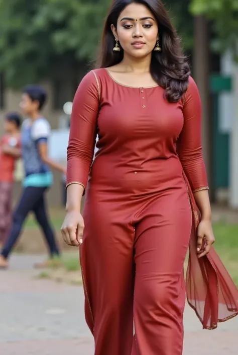 A 20-year-old Indian college girl flaunts her fit physique in a stylish salwar kurta, her medium boobs subtly accentuated by the well-tailored top, as she confidently struts across the bustling university campus.