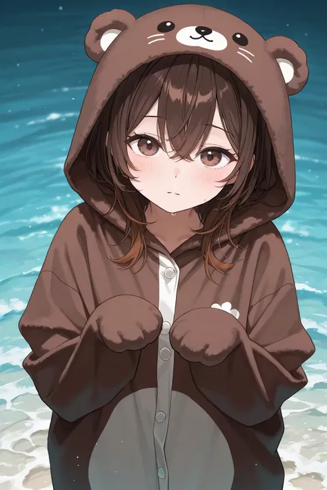 Woman with dark brown hair and eyes wearing an over sided brown sea otter onesie