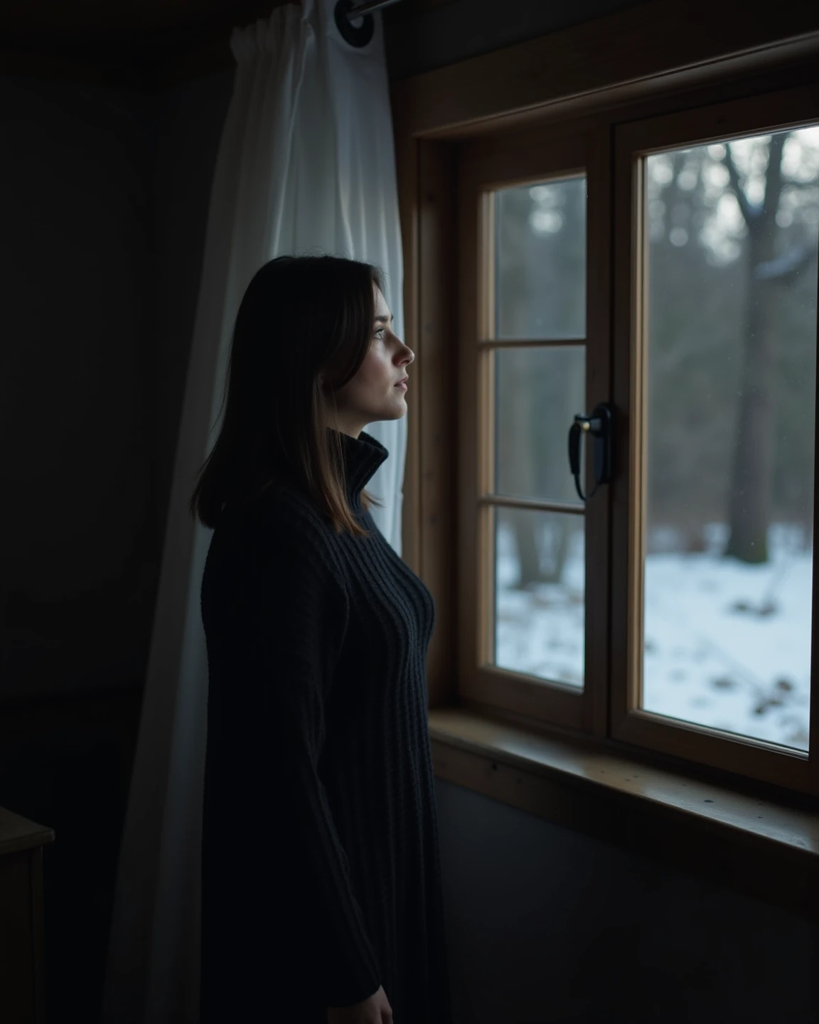 Make a realistic and high resolution (8k) and detailed photo of a woman with caramel colored skin and shoulder length black straight hair in a long black sweater dress looking out of a window from a dark cottage house room with snow outside on the ground