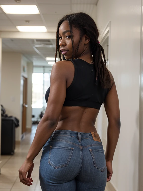 African black woman, very dark ebony skin, dreadlocks, Fitness musclular body, white crop top, , With half-down jeans revealing red panties, office corridor, close-up portrait, from behind 