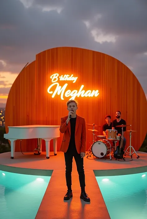 Young blond man with short hair wearing an orange blazer and a black dress shirt performing on a stage holding a wireless microphone A translucent glass walkway stretches
over a floodlit infinity pool, leading to a
floating circular stage. The vibrant oran...