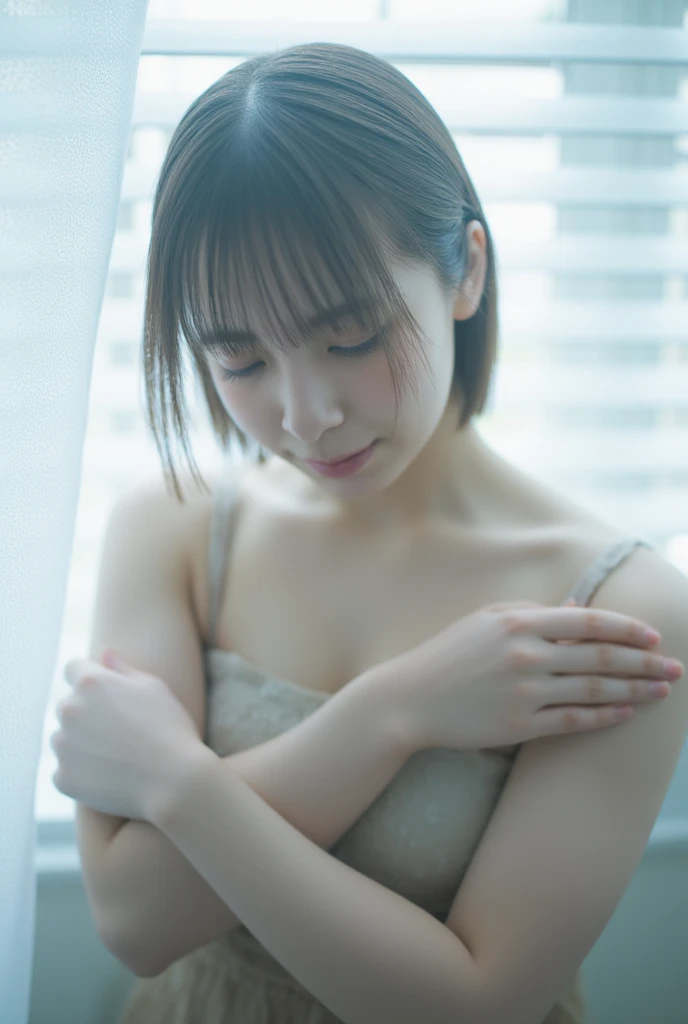 A delicate young Asian woman with slightly wet, light brown hair stands near a softly lit window, her bare shoulders exposed as she gently wraps her arms around herself. Droplets of water glisten on her smooth skin, catching the diffused light that filters...