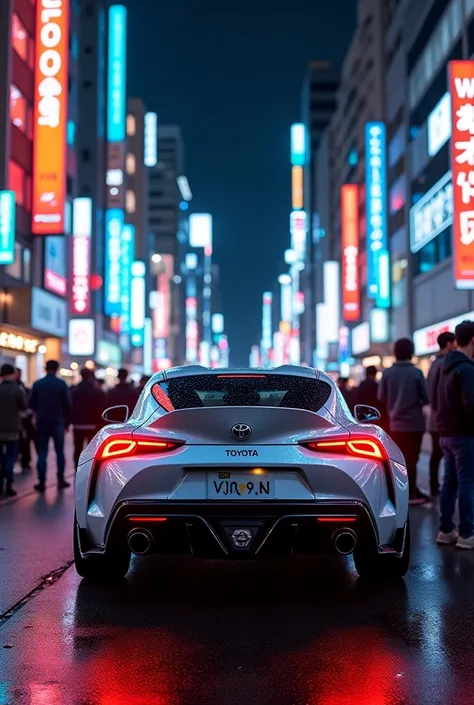 Beautiful Toyota Supra stands in Tokyo at night everyone takes pictures with neon 