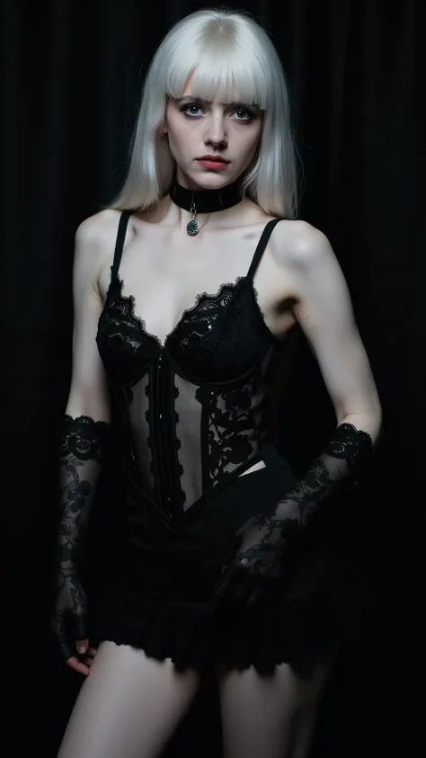 A young woman with very pale skin and long, straight, white hair is shown from the knees up. She is wearing a black, ruffled mini-skirt, black lace gloves that extend to her elbows, and a black corset-like top with thin straps.  The top is sheer, revealing...