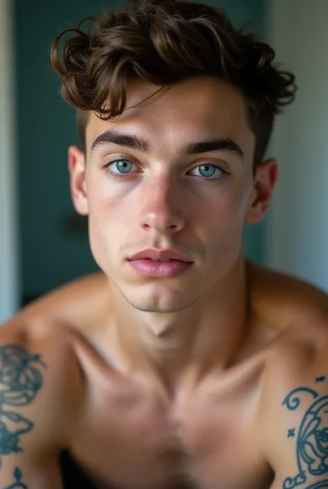 young, athletic and handsome canadian, bathroom mirror, 19 years, tattooed arms. His eyes are a striking, almond-shaped blue, and his arched, thick brown eyebrows accentuate them.  Medium-length, brown eyelashes frame his eyes.