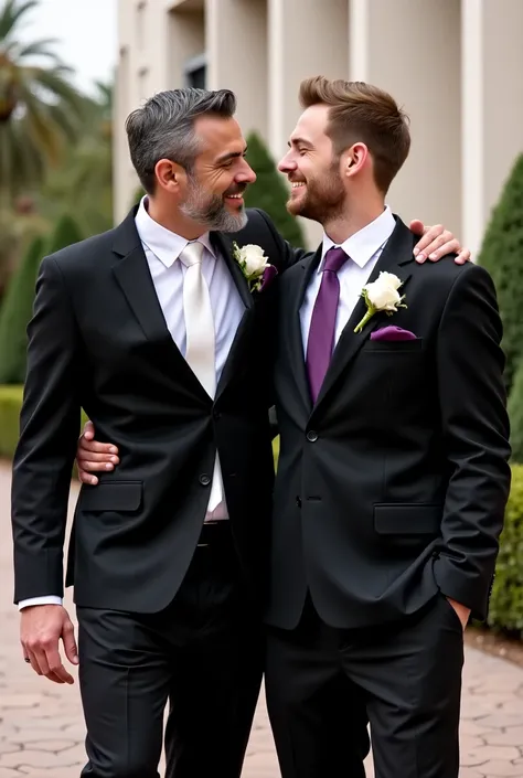  Tall and muscular Arab man  ,    with slightly gray hair and slightly gray beard   ,  dressed in a black two-piece suit  , white shirt and white silk tie ,  affectionately embracing a young blond man with short brown hair brushed backwards,   with beard a...