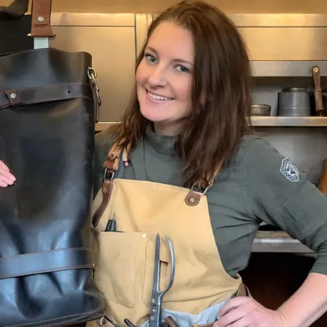 woman holding a black bag with a handle and a pair of scissors, leather apron, blacksmith apron, wearing an apron, carrying a saddle bag, wearing adventuring gear, girl with warship parts, tool belt, female blacksmith, artist wearing overalls, toolbelt