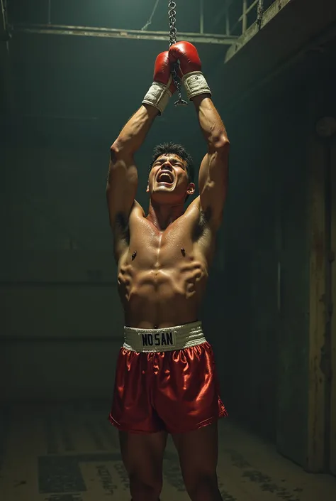 Sweaty young Ryan Garcia in handcuffs and satin boxing trunks cries while hanging by his wrists from the ceiling