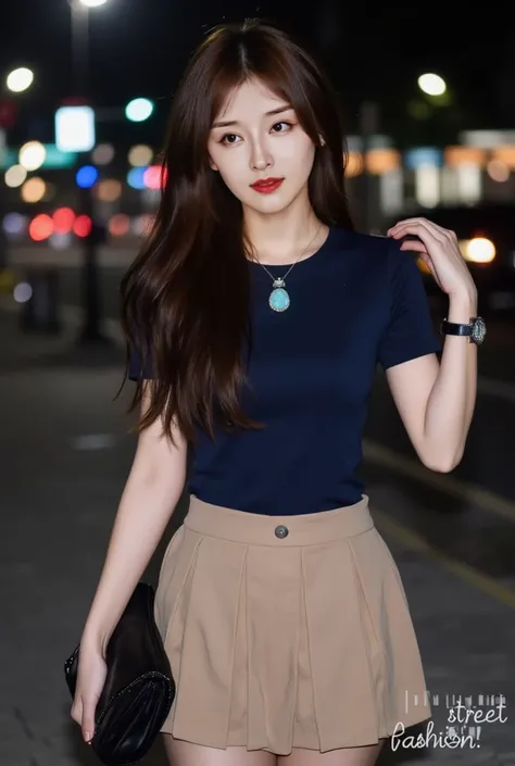 The image shows a young asian woman standing outdoors at night. She is wearing a navy blue short-sleeve top and a beige skirt. She has long, wavy brown hair and is accessorized with a necklace featuring a large turquoise pendant and earrings. In her right ...