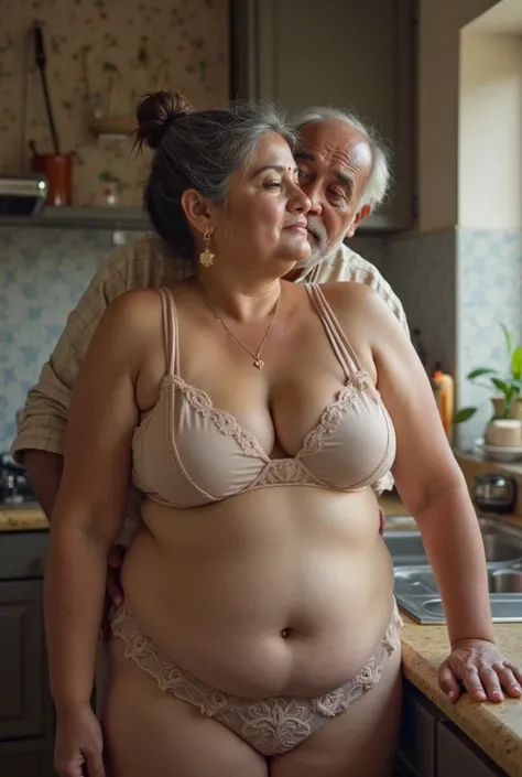 image of Voluptuous plumpy south Indian bbw chubby milf Mature aunty at the age of 40, white skin body, wearing a transparent bra and pantie only , Standing in kitchen and a old man is kissing her from behind her, bright light . She is having a salt and pe...