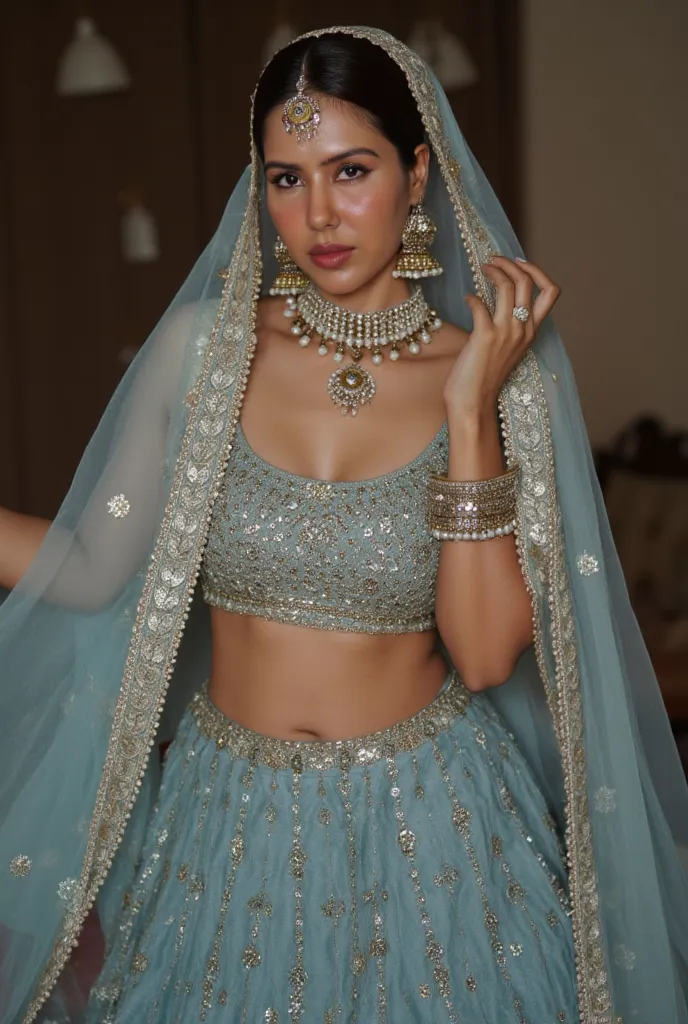 (masterpiece, best quality:1.2), She is draped in a low waist peacock blue lehenga with delicate gold embroidery, giving her an ethereal, moonlit glow. Her champagne sheer veil barely grazes her bare stomach, fully exposing her deep navel and slim waistlin...