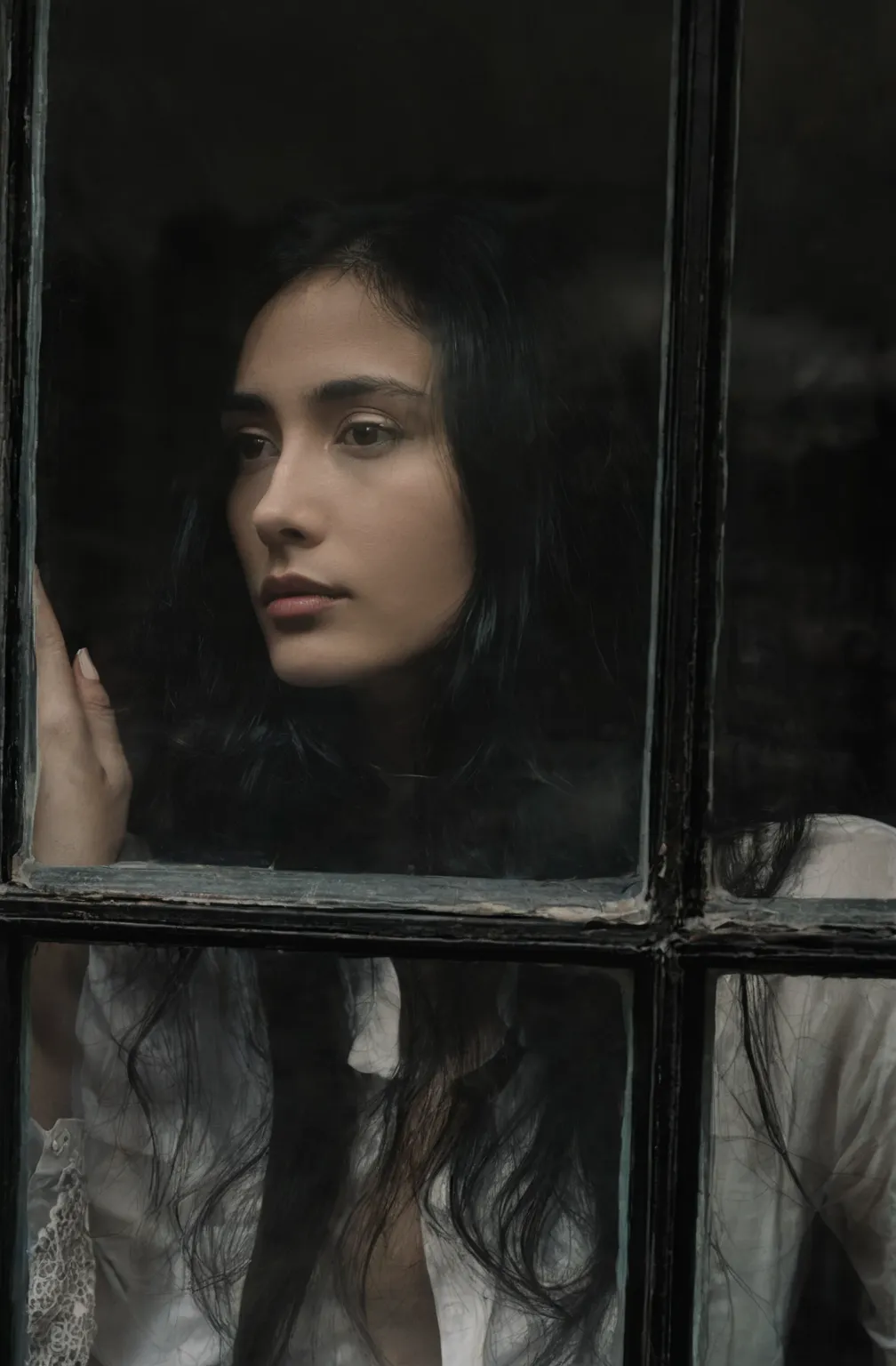 arafed woman very long dark hair, looking out a window with a white shirt on, lofi portrait at a window