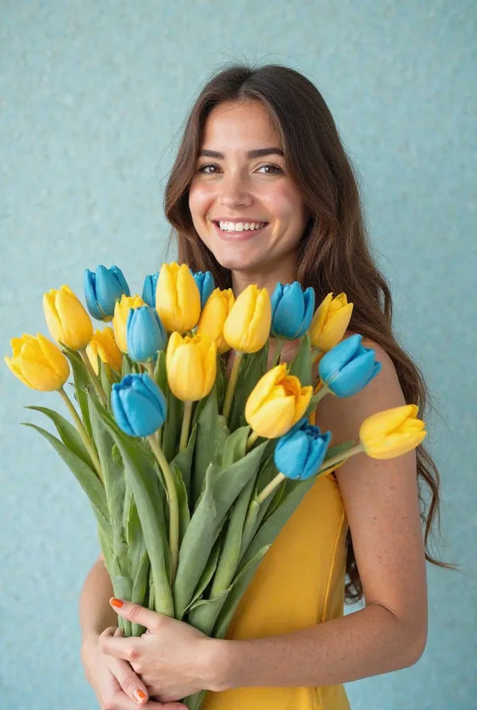 On a light background, a pretty brunette girl with long hair smiles and holds a large bouquet of yellow and bright blue tulips in her hands