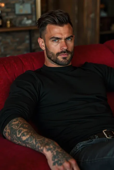 Sexy man with a square jaw, Broken jaw, high, very muscular and tough, muscular arms with tattoos, he is sitting on a red couch, tattoos leaning back as if you had all the control, with the strong outstretched arms of a club, Wearing a black sweater with h...