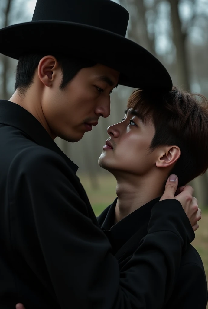 An emotional, melancholic scene with two Korean men close together. The taller man, with black hair, blue eyes, wearing a cowboy hat and black clothing, gently holds the face of the shorter man. The taller man is defined, not very muscular, and fully dress...