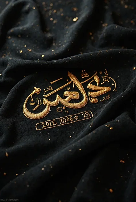 A black piece of fabric with a golden script written like sewing with a name and date of birth 
Raghad Al Abdullah 
2006\1\29