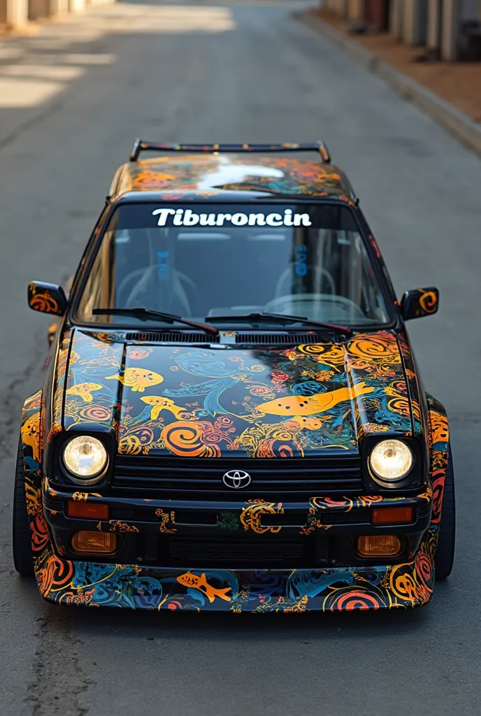 Toyota Levin 92 two-door car, the car is black with a design taken from the combination of colors of the fish that makes Gill in the movie Finding Nemo, on the windshield is written Tiburoncin 