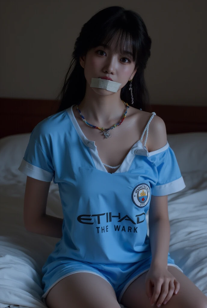 sexy woman wearing manchester city jersey tape gagged in the bedroom