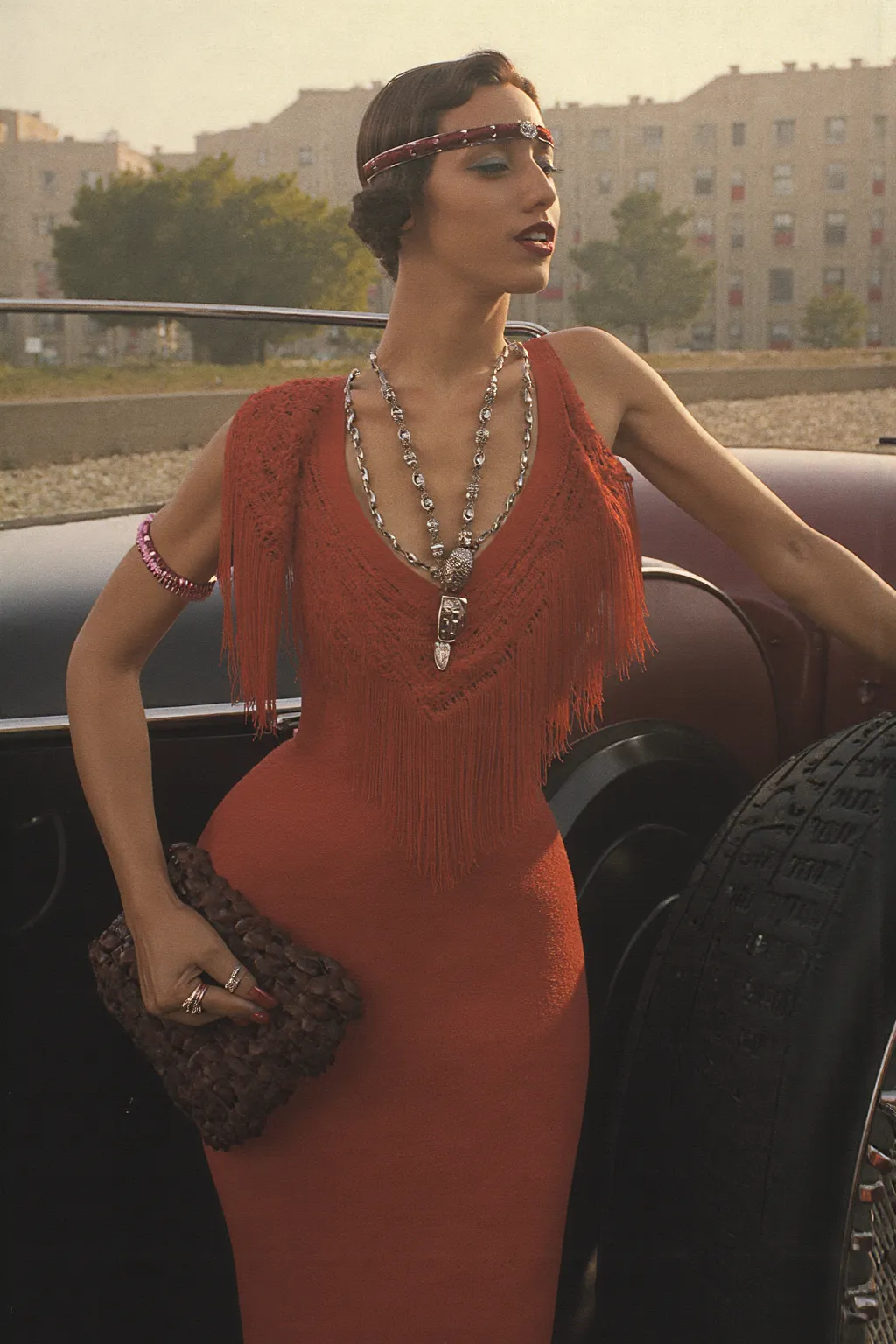 Ультрареалистичная  vintage photo , 1920s Great Gatsby style, cinematic ambience. Glamorous young woman in an authentic 1920s flapper dress, , adorned with intricate beading and fringe, open-top steps-vintage luxury car, , like a Rolls-Royce Phantom I or D...