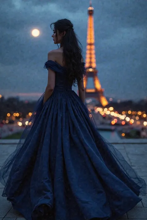 A beautiful maid of honor with black hair in a dark blue satin dress with off the shoulders and a long scarf around her neck near the Eiffel Tower at night