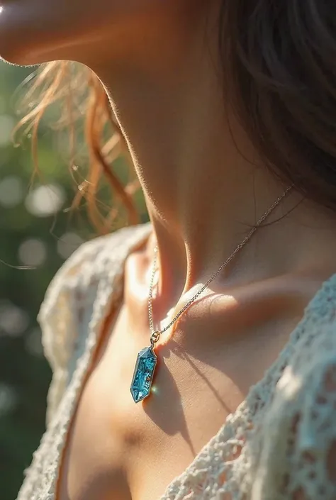 necklace with a small crystal pendant encrusted with blue stones