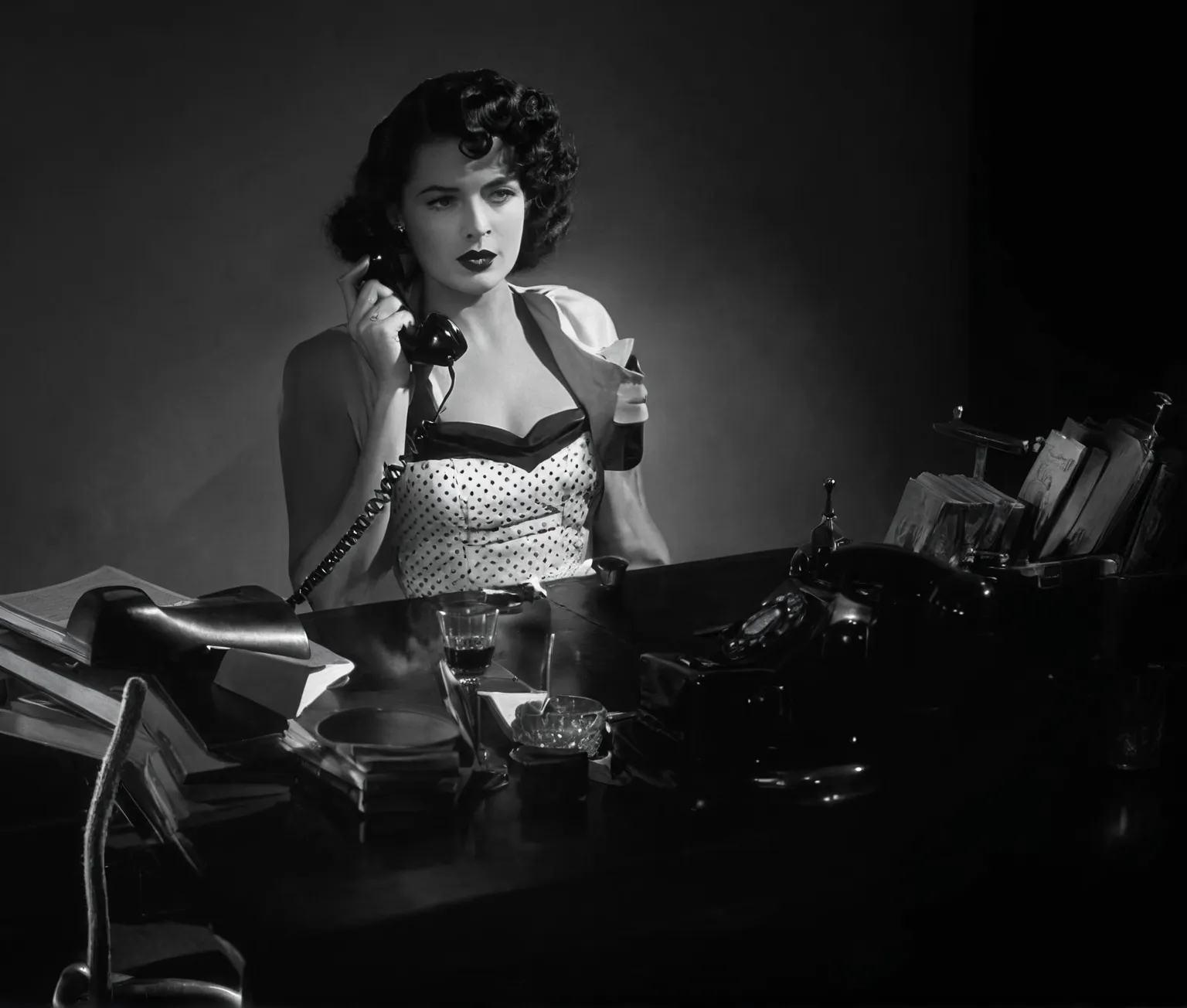 arafed woman in a dress talking on a telephone at a desk, vintage noir, film noir lighting, film noir style, 1940s film noir, classic film noir, film noir realistic, typewriter, glass of whiskey, ashtray, desk lamp, books