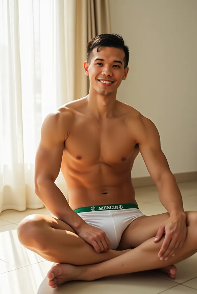 A Thai man with fair skin and a youthful appearance is sitting on a light-colored floor with a relaxed posture. He is wearing a pair of white MENCCINO briefs with a green waistband. His well-defined muscles, especially in his chest and arms, are visible, r...