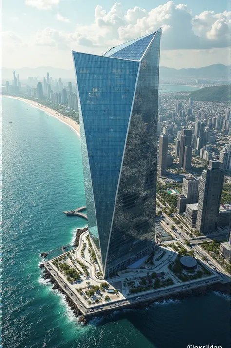 Birds eye view of skyline with parallelogram shaped glass building on side of ocean.