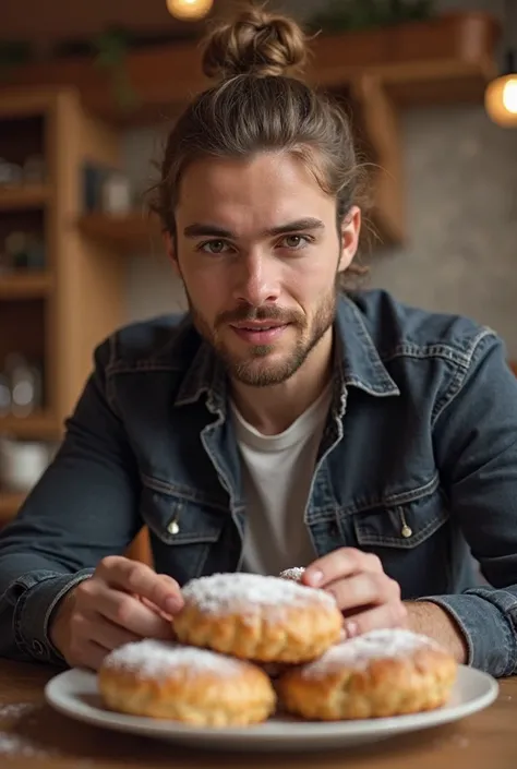 A 30-year-old boy with a short beard and brown hair and a bun eating filloas