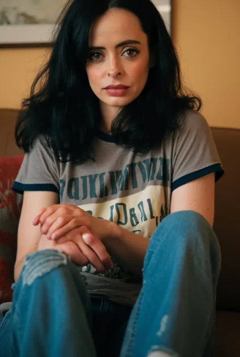 photoshoot, Krysten Ritter sitting on a couch facing you, low camera angle, wearing tight jeans, wearing a grey ringer t-shirt, stern, domineering expression, dominating, looking right at you, absurdres, high resolution, highly detailed, 4k