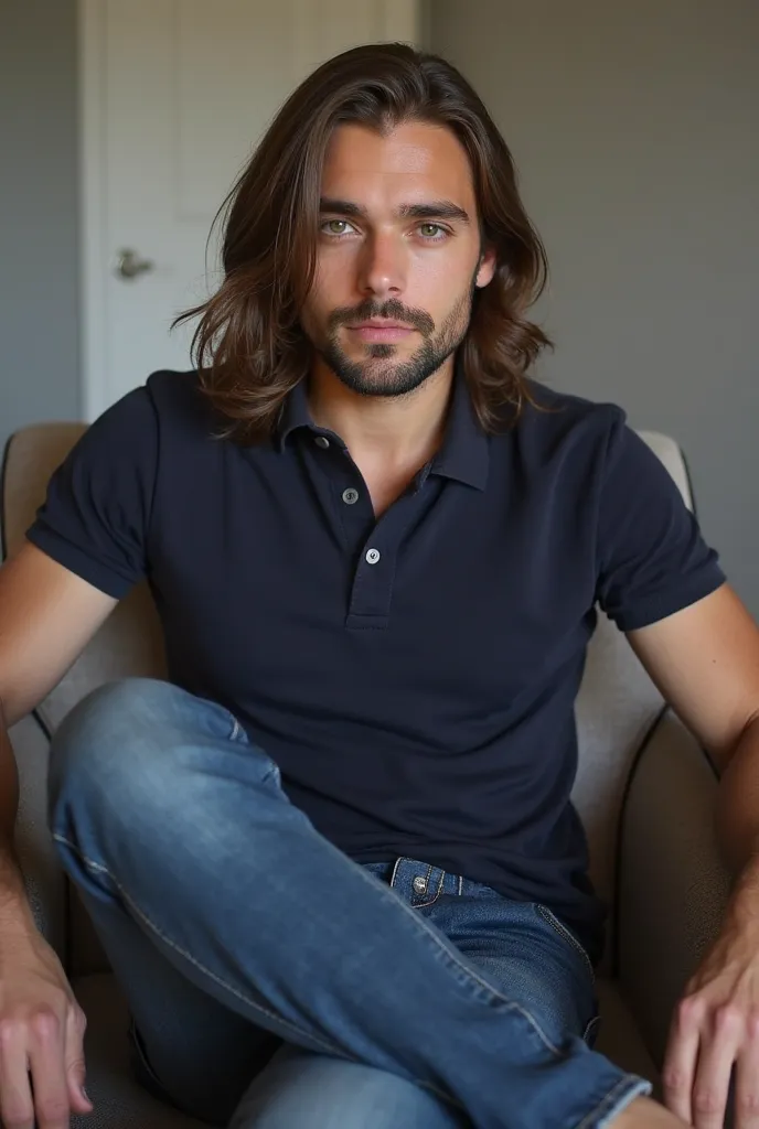 A man with straight and long brown hair. He has mixed features, big almond-shaped eyes,  straight nose, full lips and round face. He is a handsome young adult. The man is sitting in a chair, wearing a navy blue polo shirt and jeans