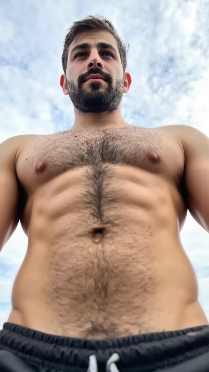 An extremely muscular man with slightly tanned skin viewed from an extremely low angle, with the arms extended forward. His bare torso shows a marked abdomen with well-defined muscles and natural body hair. His face is serious and his hair is short and sli...