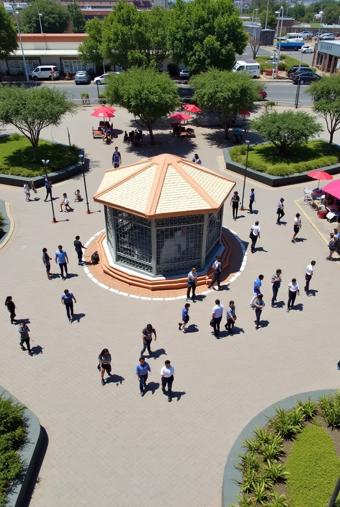 The image shows a public square with a central bandstand, surrounded by a metal grid. The roof of the gazebo is made of inclined ceramic tiles, and the base is covered in white tiles and oranges. Around the bandstand, there are people walking, talking and ...