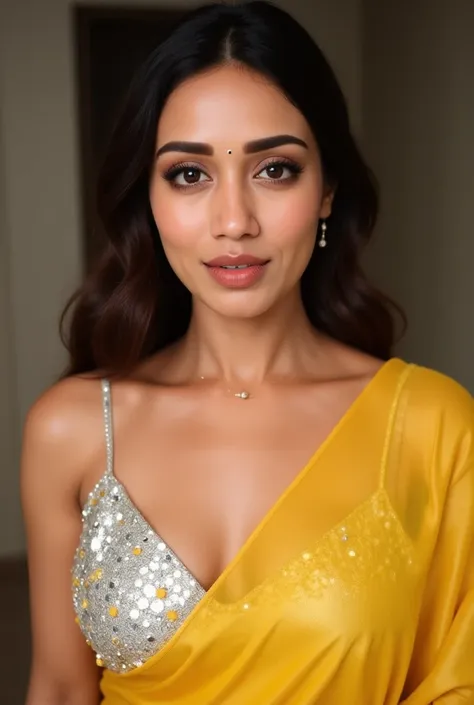 Generate a ultra realistic close up image of a woman in a golden yellow transparent sleeveless saree. She is wearing a silver shimmering blouse with mirror sequins. It has no sleeves, has a silver satin finish with spaghetti straps. Face and body facing st...